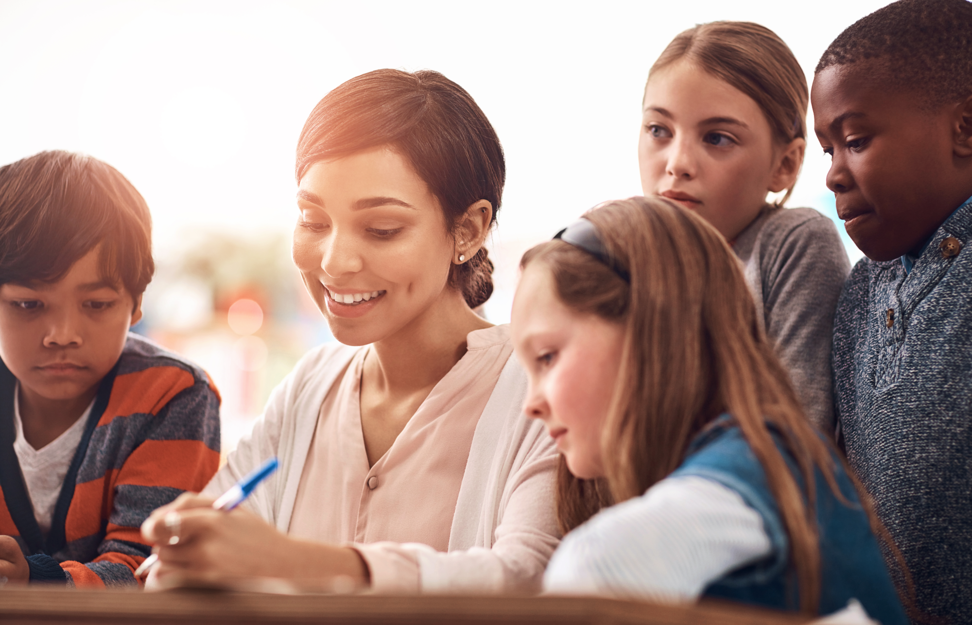 Teacher instructing four upper elementary students